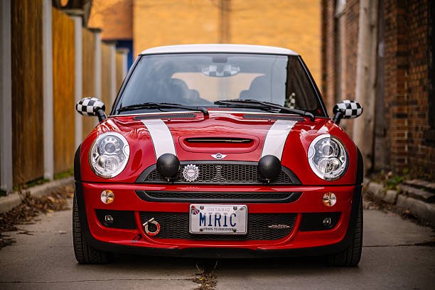 Toronto, Canada- December 25, 2015. 2006 Mini Cooper S JCW small vehicle parked against urban architecture in East End of Toronto, Ontario. This MINI Cooper S is no ordinary JCW R53 model, it is one of 64 limited edition series for Canadian market only named Competition Edition. Vehicle in the photo is #40 . Mini has been around since 1959 and has been owned and issued by various car manufacturers. It is currently distributed as a BMW brand of vehicles.
